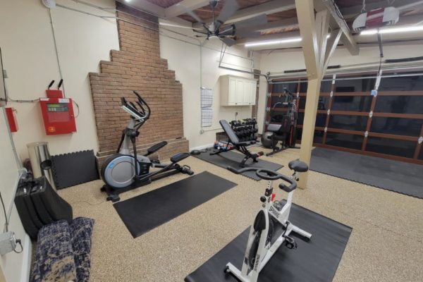 Home gym with free weights, exercise bikes, and elliptical machine